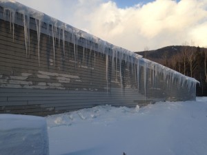 Metal Building with insufficient insulation suffering with Icicles and Ice Dams.