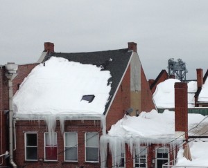 Insufficient insulation melts snow at middle of roof prematurely.